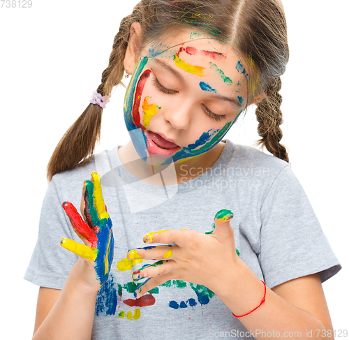 Image of Portrait of a cute girl playing with paints