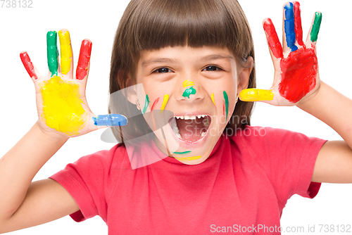 Image of Portrait of a cute girl playing with paints