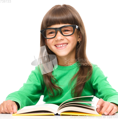 Image of Little girl is reading a book