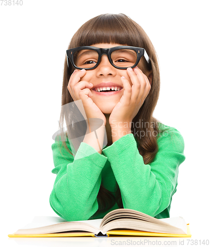 Image of Little girl is reading a book