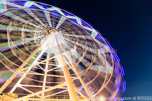 Image of Ferris wheel moving at night