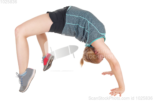 Image of Young slim woman doing gymnastics