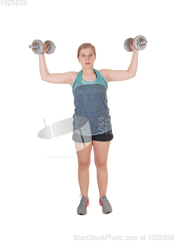 Image of Young woman lifting two dumbbell's
