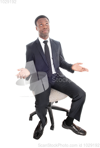 Image of Sitting business man is confused, wondering