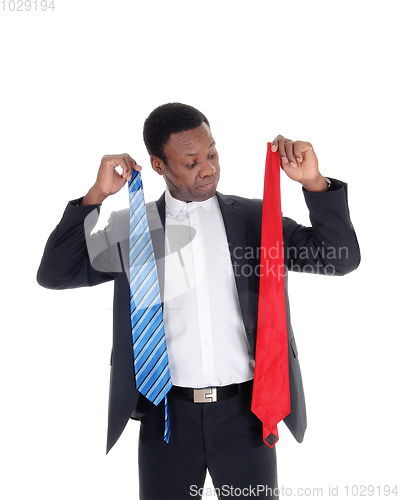 Image of Man can not decide what necktie to wear