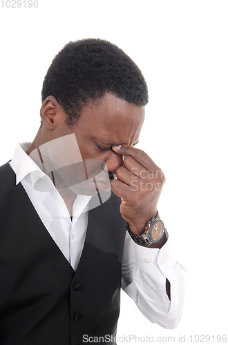 Image of Depressed African man with hand on face