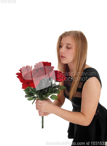 Image of Beautiful woman with a big bunch red roses