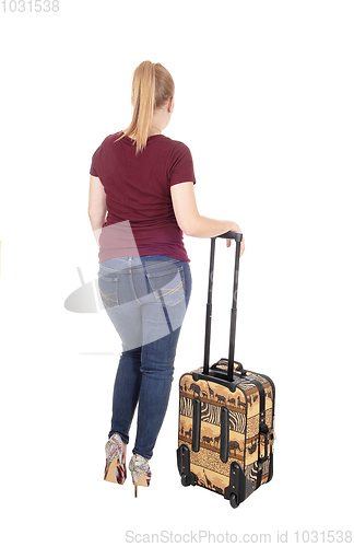 Image of Woman standing from back with suitcase