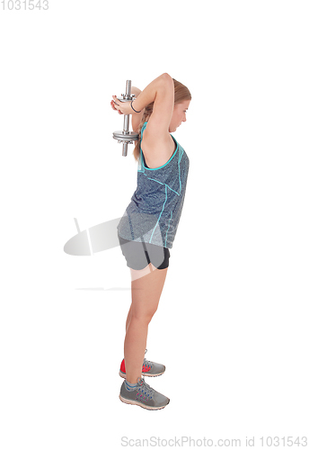 Image of Young woman lifting dumbbell's over her head