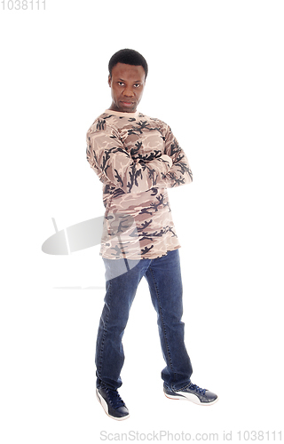 Image of African man standing in jeans and sweater