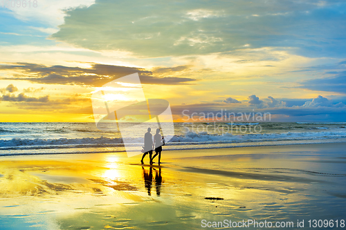 Image of Couple walking by the  beach 