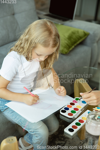 Image of Teacher and little girl, or mom and daughter. Homeschooling concept