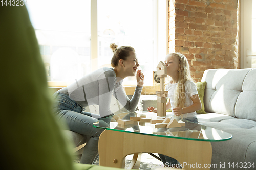 Image of Teacher and little girl, or mom and daughter. Homeschooling concept