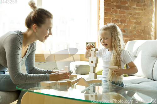 Image of Teacher and little girl, or mom and daughter. Homeschooling concept