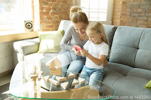 Image of Teacher and little girl, or mom and daughter. Homeschooling concept