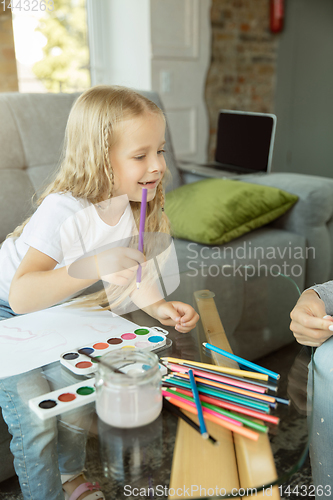 Image of Teacher and little girl, or mom and daughter. Homeschooling concept