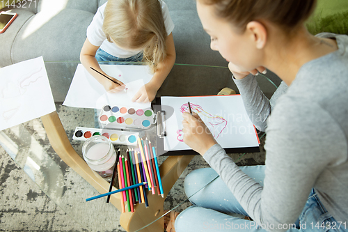 Image of Teacher and little girl, or mom and daughter. Homeschooling concept