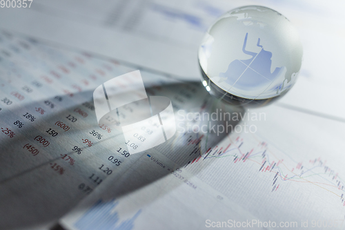 Image of Glass globe with stock charts
