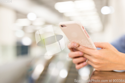 Image of Woman touch on cellphone in a station