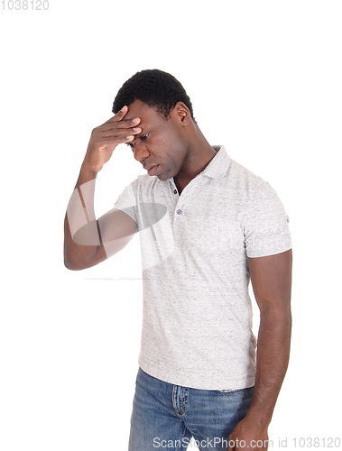 Image of Depressed looking African man standing