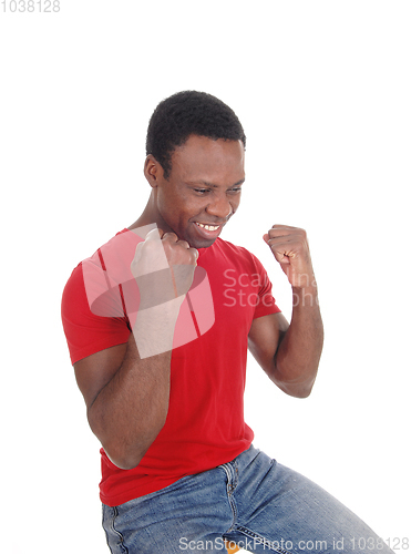 Image of Happy African man with fists, smiling