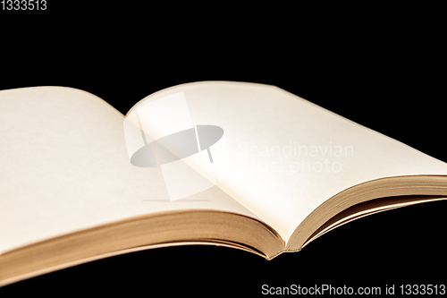 Image of Old open blank book on black background