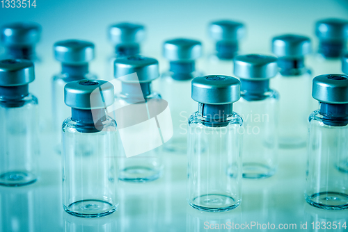 Image of Vaccine glass bottles on blue background