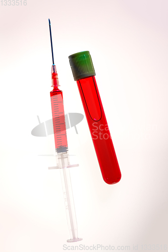 Image of Syringe and tube with blood on white background