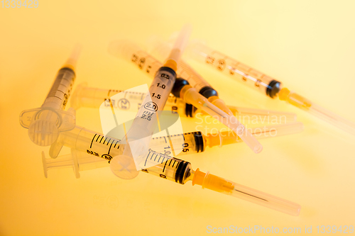 Image of Syringes on orange background