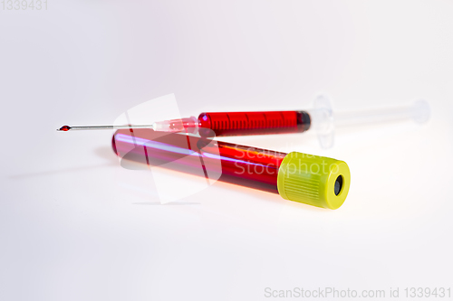 Image of Syringe and tube with blood on white background