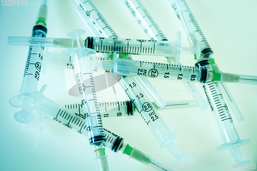 Image of Syringes on blue background