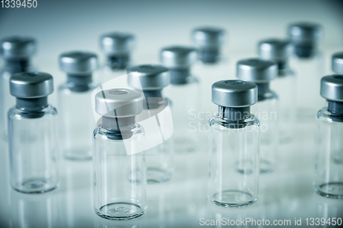 Image of Vaccine glass bottles on grey background