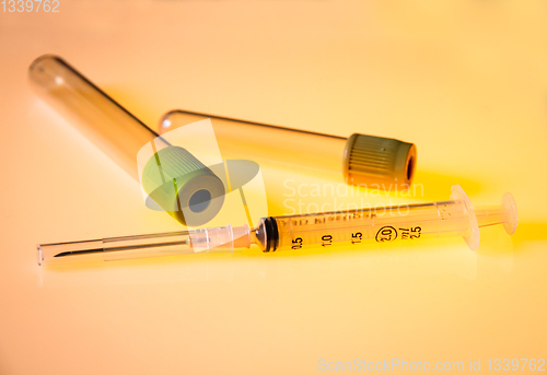 Image of Empty blood test tubes and syringe