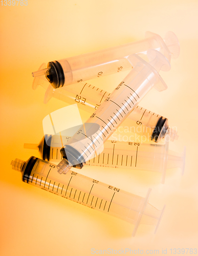 Image of Syringes on orange background