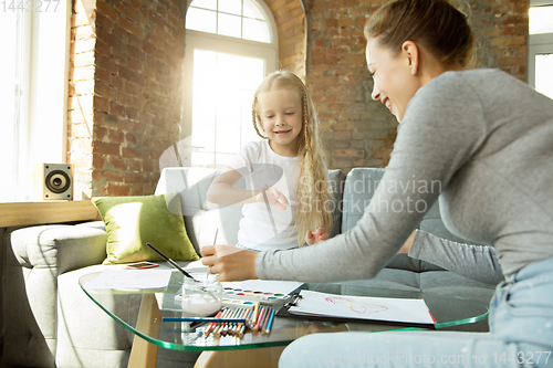 Image of Teacher and little girl, or mom and daughter. Homeschooling concept