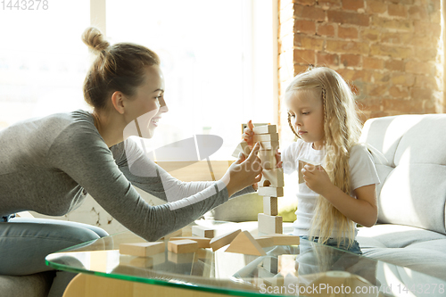 Image of Teacher and little girl, or mom and daughter. Homeschooling concept