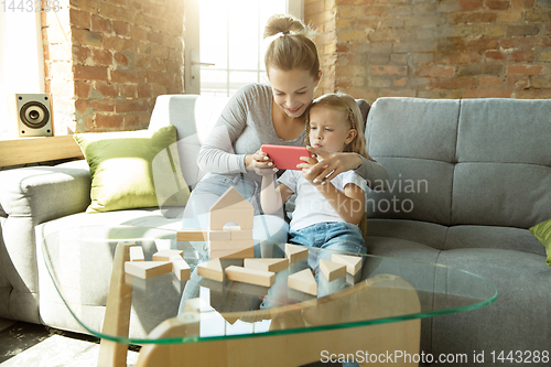 Image of Teacher and little girl, or mom and daughter. Homeschooling concept