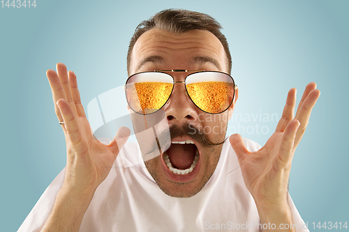 Image of Oktoberfest man with sunglasses full of light beer