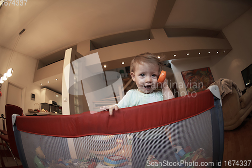 Image of cute little baby playing in mobile bed