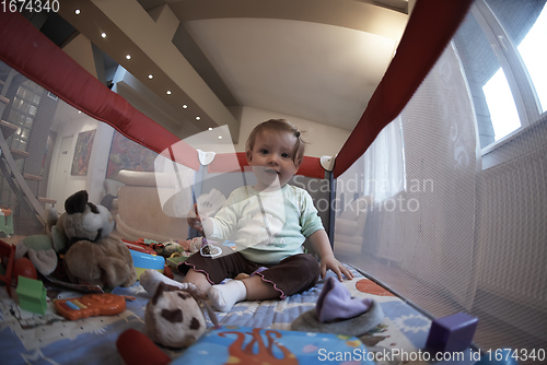 Image of cute little baby playing in mobile bed