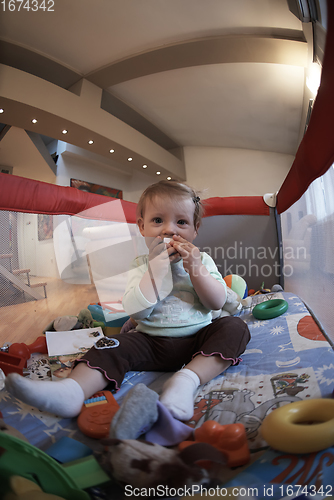 Image of cute little baby playing in mobile bed