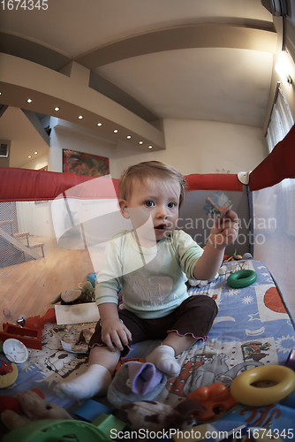 Image of cute little baby playing in mobile bed