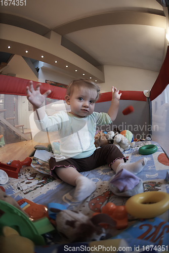 Image of cute little baby playing in mobile bed