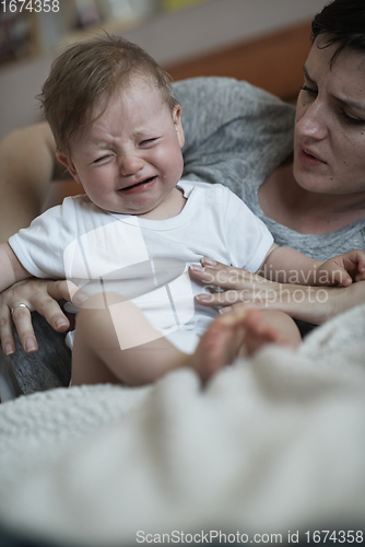 Image of mother is playing with baby at home