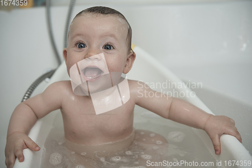 Image of cute little baby girl taking a bath