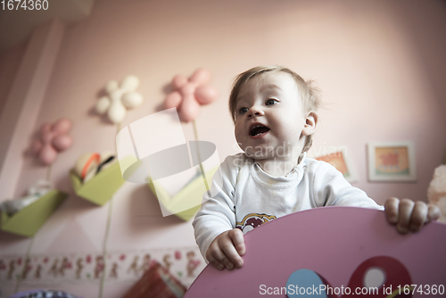 Image of cute little one year old baby and making first steps