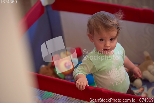 Image of cute little baby playing in mobile bed