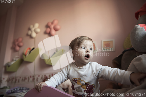 Image of cute little one year old baby and making first steps