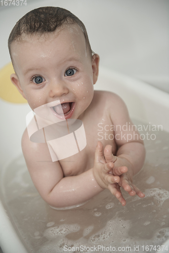 Image of cute little baby girl taking a bath