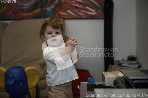 Image of Adorable cute beautiful little baby girl playing with toys at home